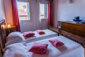 a bedroom with two beds and a dresser and a window at Agriturismo Dai Gobbi in Fara Vicentino +88 photos