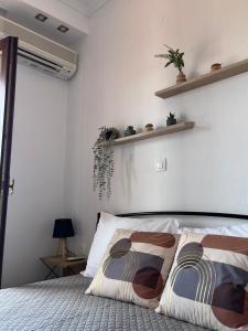 a bedroom with a bed with two pillows on it at Seaside Athos I in Ouranoupoli