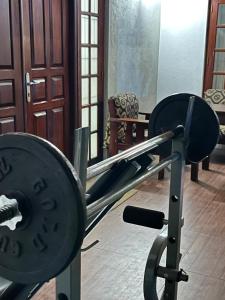 a gym with a barbell in the middle at Eightyseven guest and restaurant in Badulla