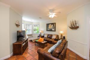 a living room with a couch and a tv at Villa Florence in Holmes Beach