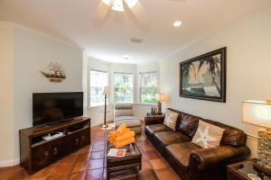 a living room with a couch and a tv at Villa Florence in Holmes Beach