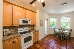 a kitchen with white appliances and a table with chairs at Villa Florence in Holmes Beach