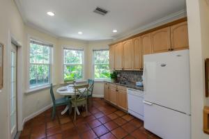 a kitchen with a table and a white refrigerator at Villa Florence in Holmes Beach