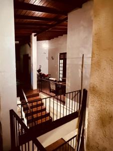 a stairway in a building with a balcony at Eightyseven guest and restaurant in Badulla