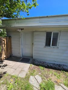 a white house with a garage with a door at Brossard room 3 in Brossard