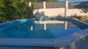 a swimming pool in front of a house at Il Nibbio in Vecchiano +5 photos