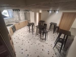 an aerial view of a kitchen with bar stools at Pensión O Novo in Treacastela +12 photos