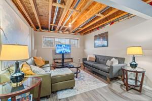 a living room with a couch and a tv at Executive 5 bdrm 3 ba House in Bonnyville