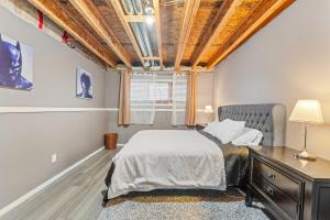 a bedroom with a bed and a wooden ceiling at Executive 5 bdrm 3 ba House in Bonnyville
