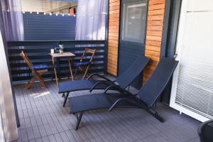 a pair of chairs and a table on a porch at Mobile Home ADRIA in Privlaka +15 photos