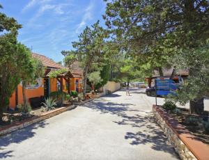 a street in a neighborhood with houses and trees at Mobile Home ADRIA in Privlaka