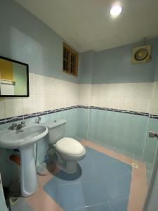 a bathroom with a toilet and a sink at Maeganbeverly's Place in Santa Fe
