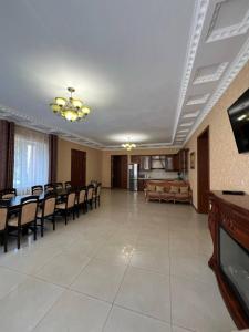 a large living room with chairs and a dining room at Admiral in Koblevo