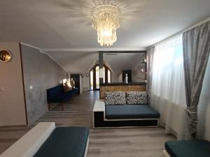 a living room with a couch and a chandelier at Proprietate privata in Lazu