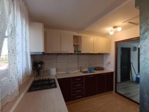a kitchen with a sink and a stove top oven at Proprietate privata in Lazu +22 photos