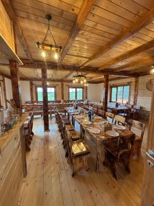 a large dining room with wooden tables and chairs at ETNO SELO VEZIROV RANČ in Sjenica