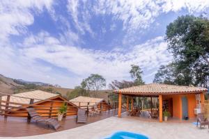 a house with a deck with a view at Pousada Vale Verde com café da manhã in Lindóia