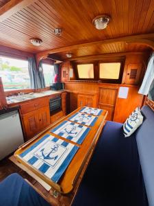 a wooden table in the middle of a kitchen at Nuit de quiétude sur un bateau et dans l'eau in Condrieu