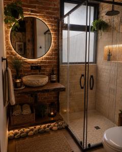 a bathroom with a glass shower and a sink at Cielito Querido in Mineral del Chico