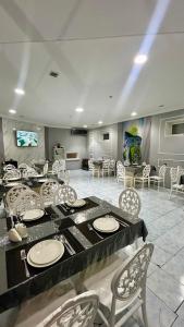 a large dining room with a table and chairs at Garden Sheki Hotel in Sheki
