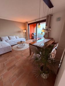 a living room with a couch and a table at Perla di Lago Maggiore in Oggebbio +21 photos