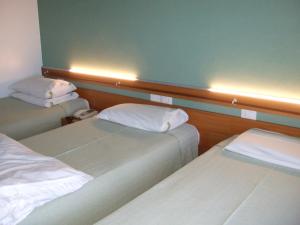 Postel nebo postele na pokoji v ubytování Hotel Canturio