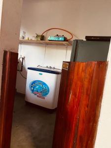 a washer and dryer in a room with a refrigerator at KR Villa in Arugam Bay +7 photos