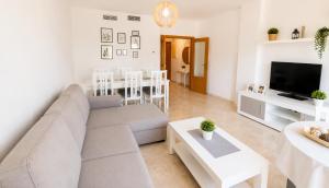 a living room with a couch and a table at LyriosHomes Beach Costa Ballena in Chipiona