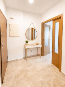 a hallway with a dressing table and a mirror at LyriosHomes Beach Costa Ballena in Chipiona