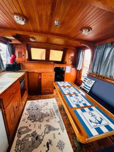 a small kitchen with a table in the middle of it at Nuit de quiétude sur un bateau et dans l'eau in Condrieu