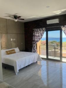a bedroom with a bed and a view of the ocean at STELLA MARIS Boutique Hotel in El Sargento +53 photos
