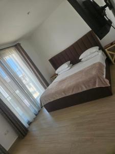 a bedroom with a bed and a large window at Waterfront Accommodations Villa 3B in Bijilo