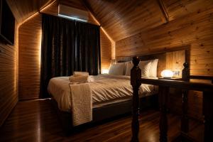 a bedroom with a bed in a wooden cabin at City Bungalow Hotel in Edirne