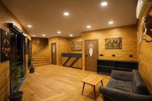 a living room with wooden walls and a couch at City Bungalow Hotel in Edirne