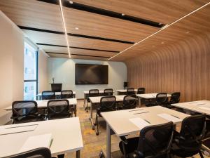a classroom with tables and chairs and a flat screen tv at Hotel Waterloo Singapore - Handwritten Collection in Singapore +93 photos