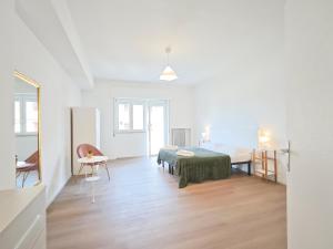 a white room with a bed and a table at Dimora Leccese in Lecce