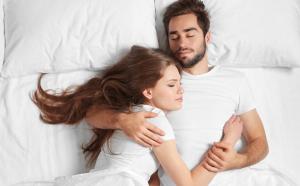 a man and a woman laying in bed at Mayflower Motel Milford in Milford