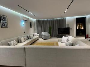 a large living room with couches and a television at شاليه مرزوقة in Buraydah
