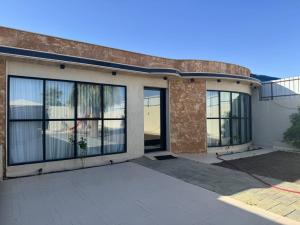 a house with large glass doors on it at شاليه مرزوقة in Buraydah +8 photos