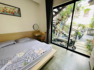 a bedroom with a bed and a large window at Đông Hương Home in Cat Ba +80 photos
