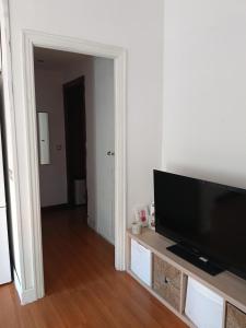 a living room with a flat screen tv on a entertainment center at Bilbao Room 001 in Bilbao