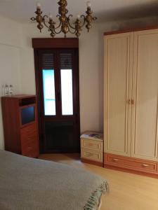 a bedroom with a bed and a cabinet and a window at Bilbao Room 001 in Bilbao