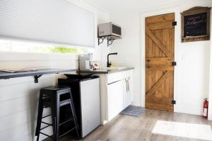 a kitchen with a counter and a sink and a door at NEW! Cozy Container Home at Cliffside #2 in Orderville