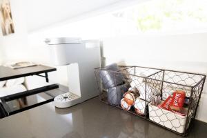 a wire basket on a counter next to a sewing machine at NEW! Cozy Container Home at Cliffside #2 in Orderville +13 photos