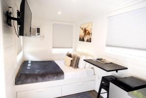 a small bedroom with a bed and a desk at NEW! Cozy Container Home at Cliffside #2 in Orderville