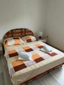 a bedroom with a bed with a quilt on it at Apartman Riverside Ripač in Ripač