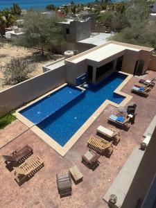 an overhead view of a swimming pool with lounge chairs and sidx sidx sidx at STELLA MARIS Boutique Hotel in El Sargento