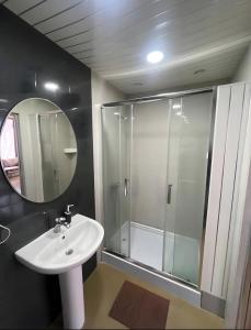 a bathroom with a shower and a sink and a mirror at DownTown Guest House in Vanadzor +28 photos