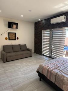 a living room with a bed and a couch at STELLA MARIS Boutique Hotel in El Sargento