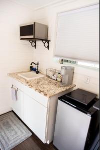 a small kitchen with a sink and a counter top at NEW! Cozy Container Home at Cliffside #3 in Orderville